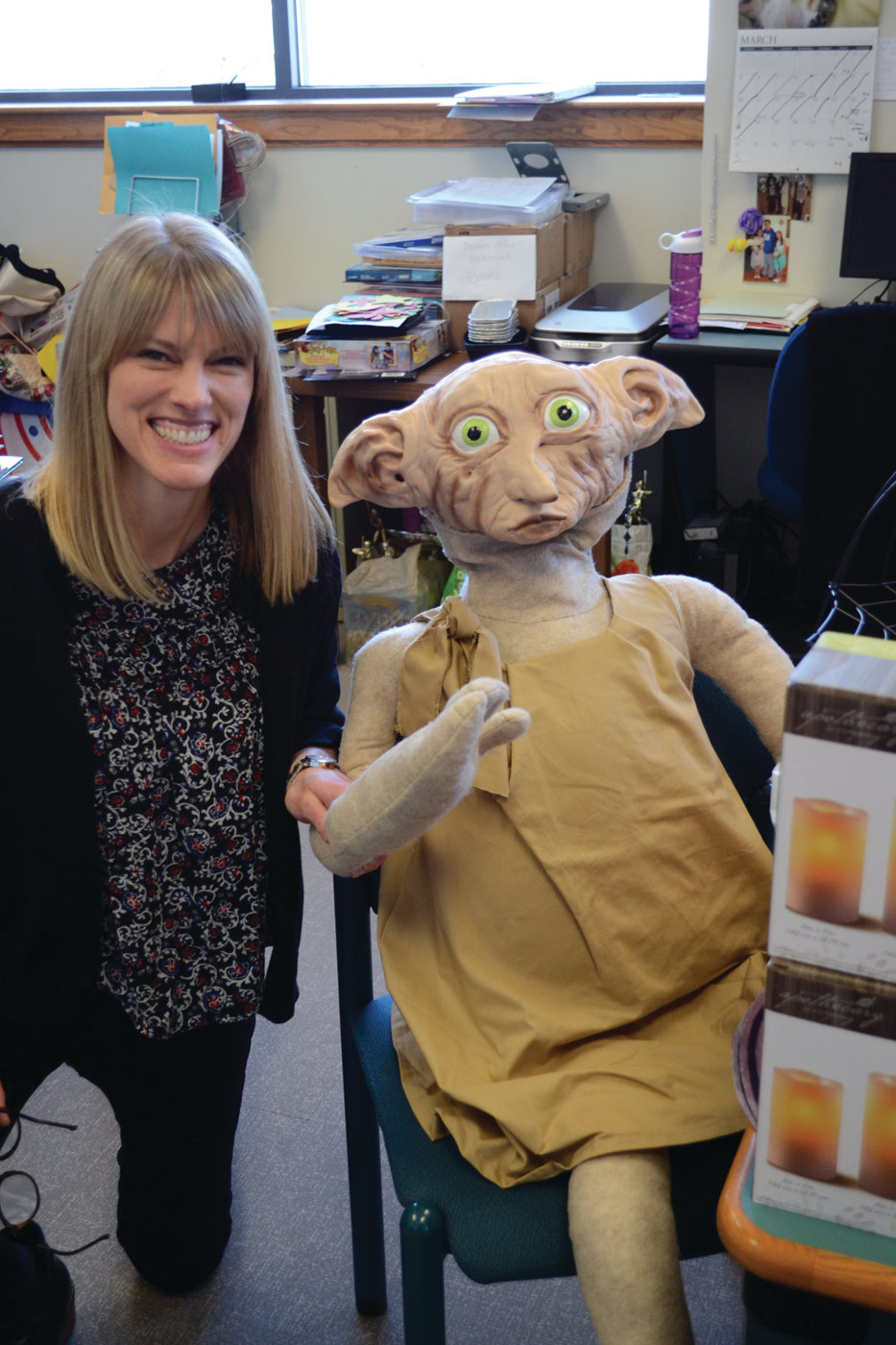 MEET NEW FRIENDS: Ellen O’Brien, coordinator of Children’s Services for the Warwick Public Library, poses with Dobby the House Elf, a central character from the Harry Potter series.